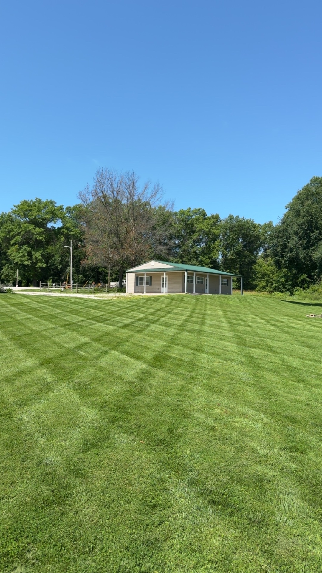 Wide open commercial property mowed with clean stripes